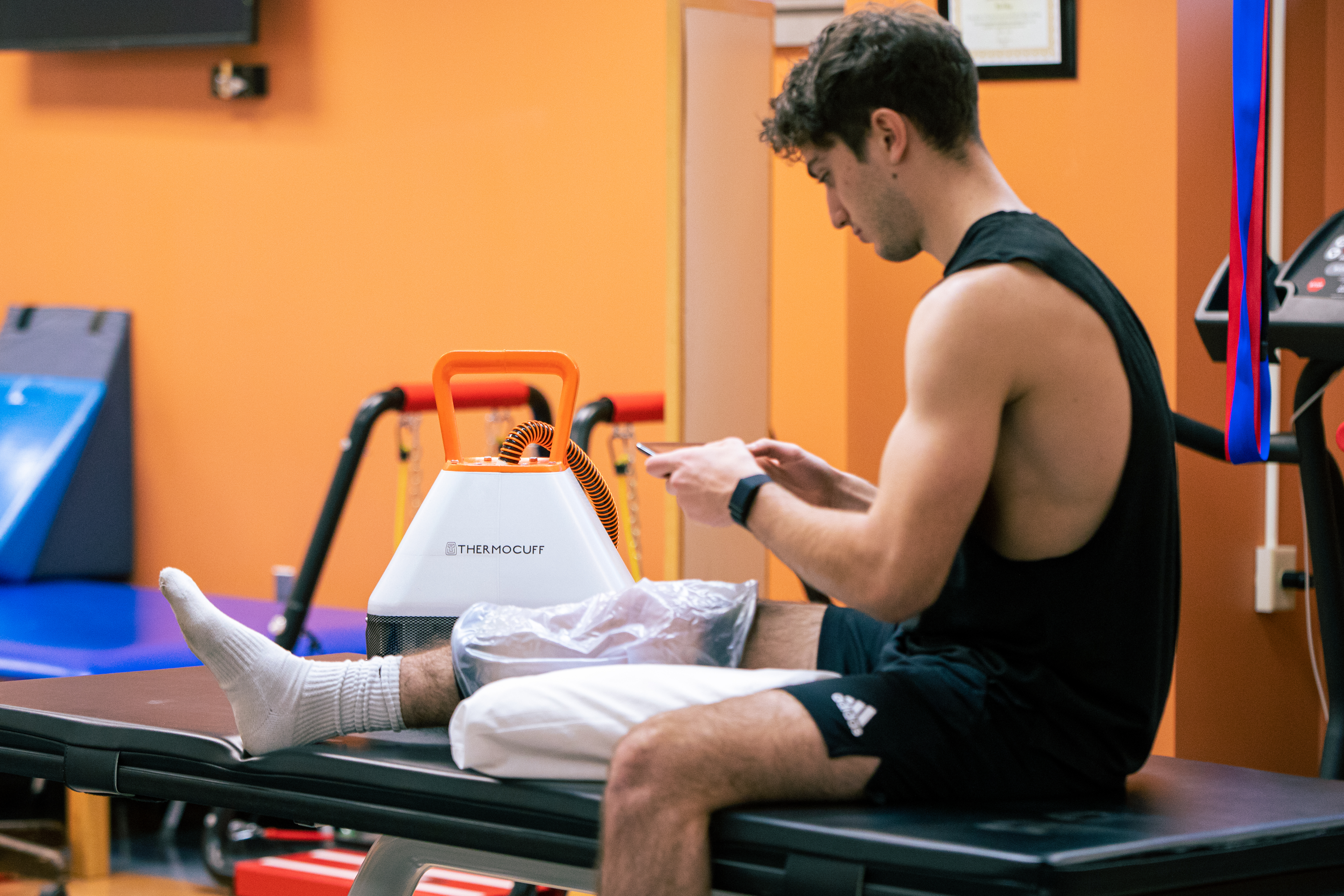 Athlete recovering with ThermoCuff cuff