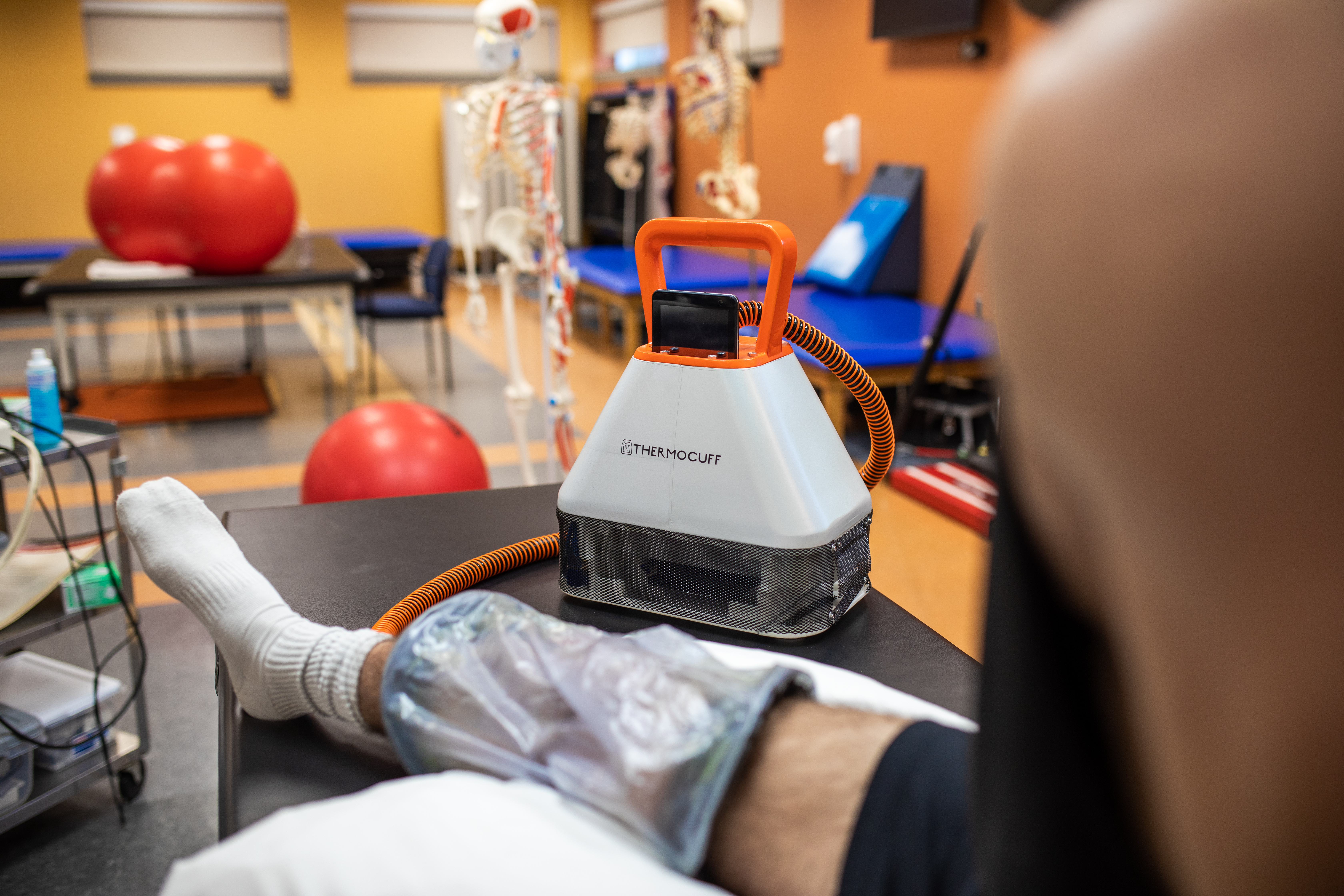 Athlete recovering with ThermoCuff cuff